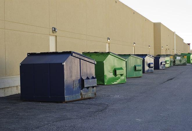 a yellow construction dumpster on a work site in Denham Springs